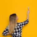 Young Woman Is Painting Pink Yellow Wall. Rear View