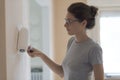 Woman painting walls at home with a paint roller Royalty Free Stock Photo