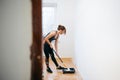 Young woman painting walls with a roller in a new house Royalty Free Stock Photo