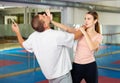 Young woman practicing palm strike with man in self defense training Royalty Free Stock Photo