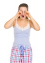 Young woman in pajamas rubbing eyes Royalty Free Stock Photo