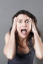 Young woman panicking expressing jaw dropping surprise