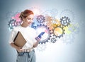 Young woman with papers and phone standing over colorful gears sketch Royalty Free Stock Photo