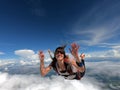 Young woman parachutist smiling in free fall. Royalty Free Stock Photo