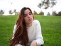 A young woman in the park looking at the camera seriously with a revengeful expression Royalty Free Stock Photo