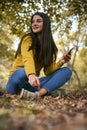 Young woman at park using smart phone. Royalty Free Stock Photo