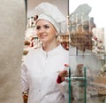 Young woman pastry chef greets visitors at the door