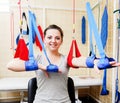 Young woman patient doing physical exercises in a rehabilitation study.