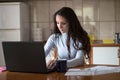 Young woman paying bills with debit card from home Royalty Free Stock Photo