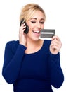 Young Woman Paying by Credit Card and Cell Phone