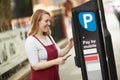 Young woman paying a parking fee Royalty Free Stock Photo