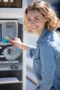 young woman paying for parking at pay station Royalty Free Stock Photo