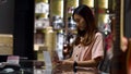 Young woman paying by scanning QR Code with smartphone