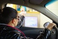 Young woman paying toll on highway at the tollbooth Royalty Free Stock Photo