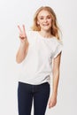 Young woman, peace sign and portrait in studio for happiness, positive and funky in casual fashion. American model Royalty Free Stock Photo