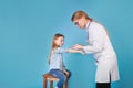 Young woman pediatrician performs a vaccination of a little girl Royalty Free Stock Photo