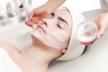 Young woman peeling foam mask applying on face Royalty Free Stock Photo