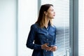 Young woman peering the Venetian blinds Royalty Free Stock Photo