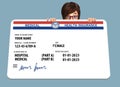 A young woman peers over a mock, generic, 2023 Medicare Health Insurance card