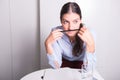 Young woman with pencil under her nose is thinking Royalty Free Stock Photo