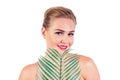 Young woman perfect skin make-up with long eyelashes and red lipstick holding a tropical palm leaf closeup shoulders Royalty Free Stock Photo