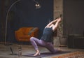 Young woman perform yoga stretching doing Anjaneyasana or Low lunge pose in modern interior home. woman practicing yoga Royalty Free Stock Photo