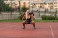 Young Woman Performing Bag Squat Exercise Outdoor Royalty Free Stock Photo