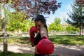 Young woman performing boxing punches training outdoors Royalty Free Stock Photo