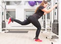 Woman exercising legs on cable crossover machine Royalty Free Stock Photo