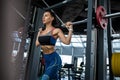 Young woman performing lunges on Smith machine at gym Royalty Free Stock Photo