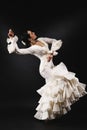 Young woman performing salsa dance with passion on black backgro