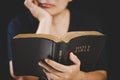 Young woman person hand holding holy bible with study at home. Adult female christian reading book in church. Girl learning