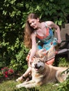 Young woman petting a dog. Summer portrait outdoors Royalty Free Stock Photo