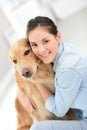 Young woman petting her dog at home Royalty Free Stock Photo