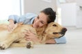 Young woman petting her dog at home Royalty Free Stock Photo