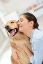 Young woman petting her dog with tenderness Royalty Free Stock Photo