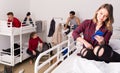 Young woman with phone on bed in hostel Royalty Free Stock Photo