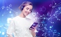 Young woman with phone and headphones, glowing social media icons Royalty Free Stock Photo