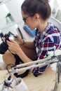 Young woman photographer checking previews on camera in the stud Royalty Free Stock Photo