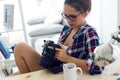 Young woman photographer checking previews on camera in the stud Royalty Free Stock Photo