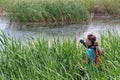 Young woman photographer in delta. Vacaresti Nature Park - landmark attraction in Bucharest, Romania Royalty Free Stock Photo