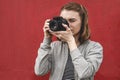 Young woman photographer focusing on the viewer