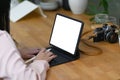 Young woman photographer or graphic designer working with tablet computer on wooden table. Royalty Free Stock Photo