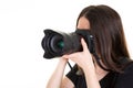 Young woman photographer holding a camera on white background Royalty Free Stock Photo