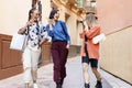 Young woman photographing cheerful girlfriends during sightseeing tour Royalty Free Stock Photo