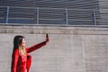 Young woman photographing herself with her phone to send a selfie to their social networks Royalty Free Stock Photo