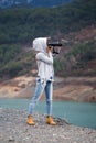 Full length portrait of young woman photographing landscape