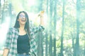 Young woman in a photoshoot raising her hand holding a smoke bomb yellow in the forest smiling at Costa Rica Royalty Free Stock Photo