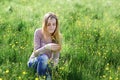 Young woman picking flowers on a summer meadow Royalty Free Stock Photo