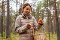 young woman picking mushrooms in autumn forest Royalty Free Stock Photo